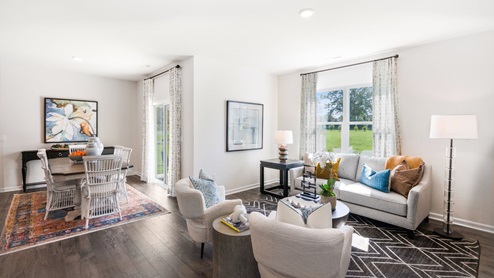 Living area with ample lighting and revwood flooring