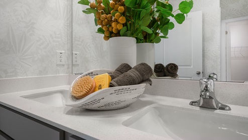 Bathroom with quartz countertops and walk in shower