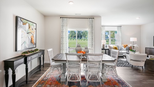 Dining area with ample lighting and revwood flooring