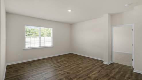 Living room with revwood flooring and large window