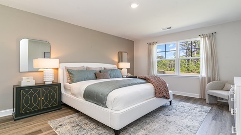 Primary bedroom with vinyl plank flooring