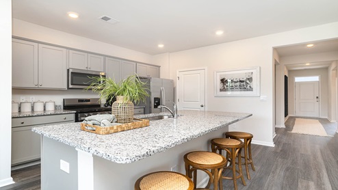 Aria kitchen with gray cabinets and granite countertops