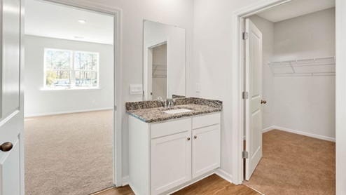 The primary suite as well as on suite is sure to impress with double vanities and a massive walk-in closet. This home boasts a large granite kitchen island that overlooks the dining area and patio, as well as a 45-degree angle pantry for ample food storage, a large, covered porch for those nice breezy sunsets! LVP floors are installed throughout the home as well as the stain resistant carpets that add comfort to the bedrooms.