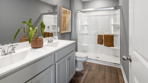 The primary bedroom has its own attached bathroom that features a walk-in closet and all the space you need to get ready in the morning. Sharing a sink isn’t a worry with the double vanity, and you also get additional privacy with a separate door for the toilet and shower.
