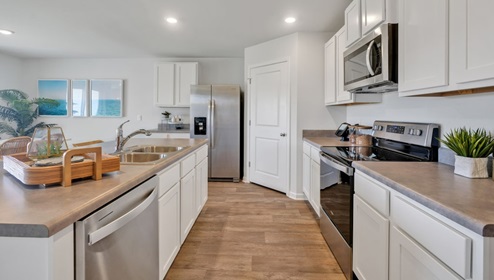 The kitchen features beautiful cabinets, granite countertops, and stainless steel appliances, which are sure to both turn heads and make meal prep easy. You’ll never be too far from the action with the living and dining area right there.