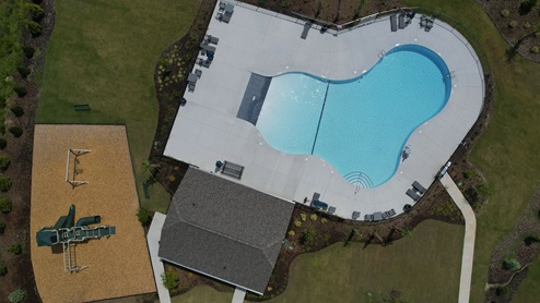 Aerial photo of pool, cabana, and playground amenity
