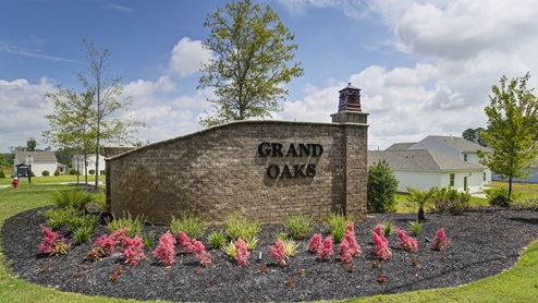 Grand Oaks entrance sign with flowers and landscaping
