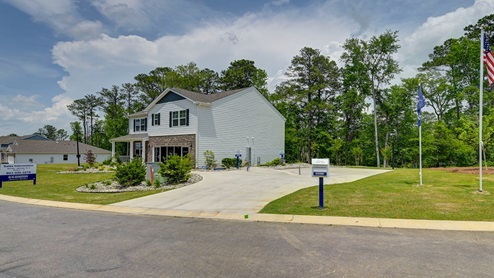 Spacious green yard backing up to the wood line