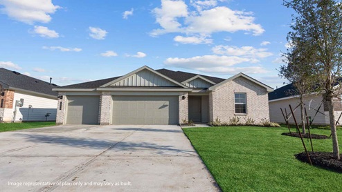 Single story brick home with a three car garage