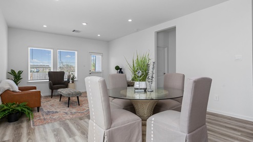 Open concept dining room and living room with two windows