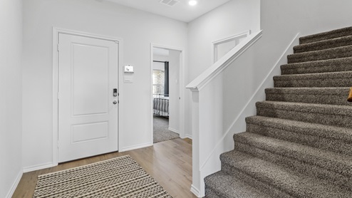 Interior entrance with hardwood floors and view of staircase