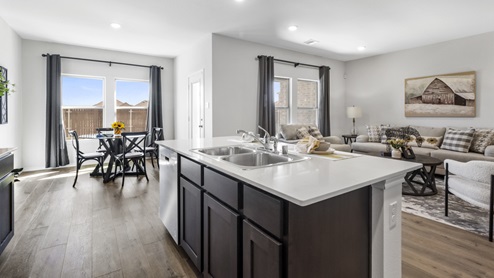 Kitchen area with hardwood floors dark cabinets and white counters