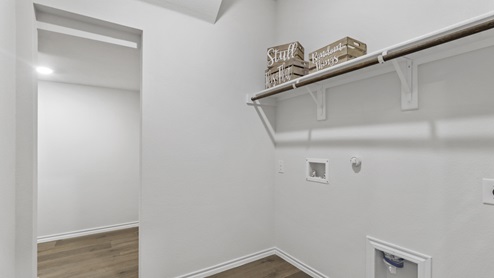 Utility area with hardwood floors for washer and dryer