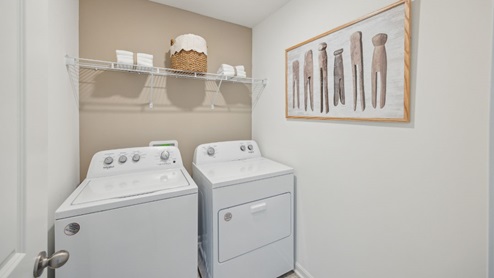 spacious laundry room with side by side washer and dryer