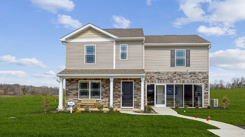 Tan and brick home with covered porch and glass front sales center in lieu of garage
