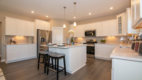 spacious kitchen with white cabinets and large island