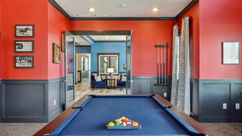 pool table and entryway of amenity building