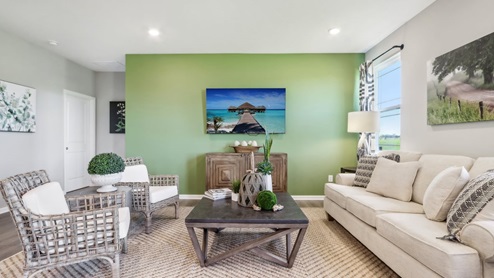 great room with green accent wall