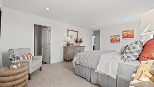Colonial heights Bellamy model home large main bedroom with carpet flooring with door to closet and bathroom