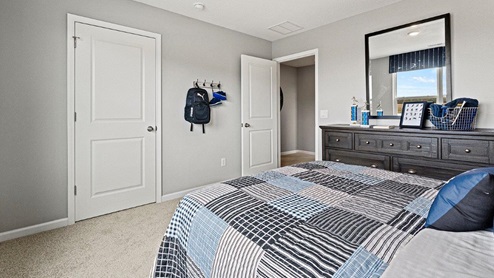 Parlor Bluffs Henley model Bedroom 2 with closet and carpet flooring