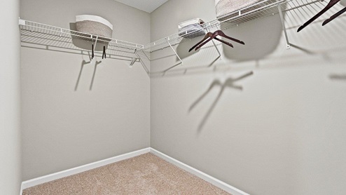 Parlor Bluffs Henley model Walk-in closet off of Main Bedroom with carpet flooring and wire shelving