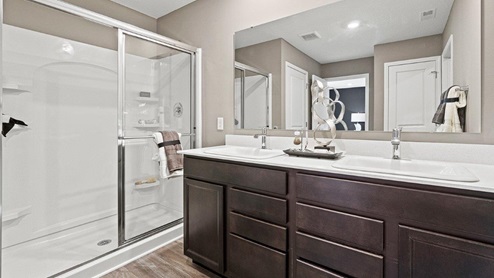 Parlor Bluffs Henley Model Walk in Bathroom with dual vanity sinks with Blanco Matrix Quartz off of main bedroom