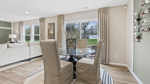 Parlor Bluffs Henley Model Dining Room with sliding glass door to backyard with LVP flooring