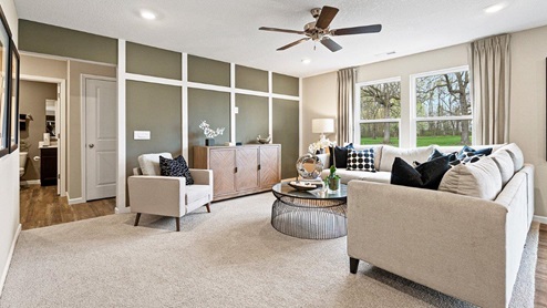 Parlor Bluffs Henley Model Home Living room with 52" ceiling fan and large windows for natural lighting
