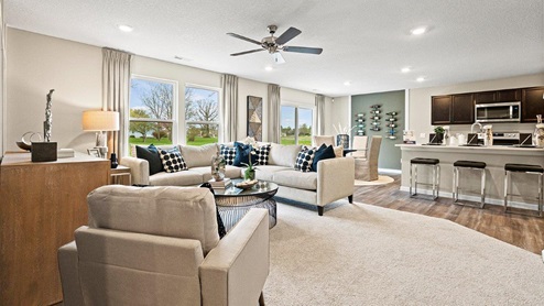 Parlor Bluffs Henley Model Home Open concept floor plan for kitchen, dining room, and living room with LVP and carpet flooring