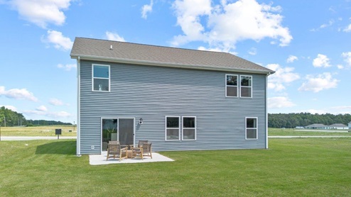 Parlor Bluffs Henley Model Home rear exterior with 12x12 uncovered concrete patio and sodded backyard