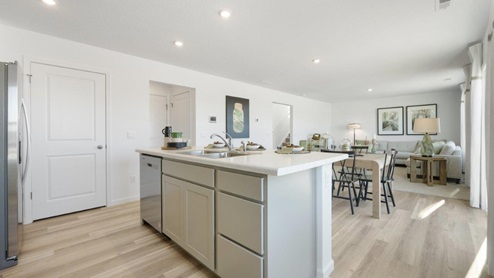 Grasslands at Broad Acres Bellamy Model large island with extra cabinet space, sink, and dishwasher