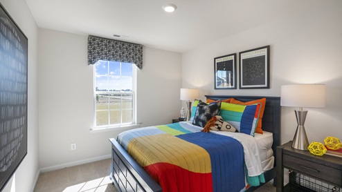 Bedroom with large main bedroom and modern lamps and bedside tables.