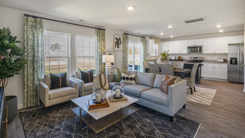 Modern open concept great room with large windows and beautiful décor.