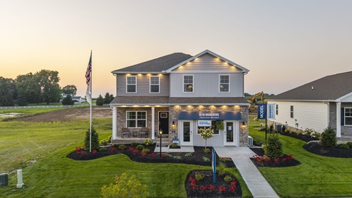 Front exterior of model home at Grandstone Trace community at Dusk