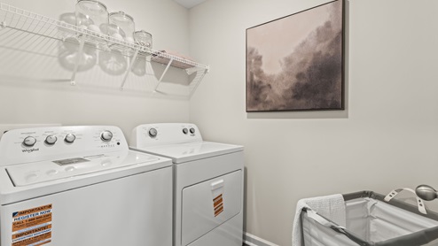 Laundry room with hanging storage rack.