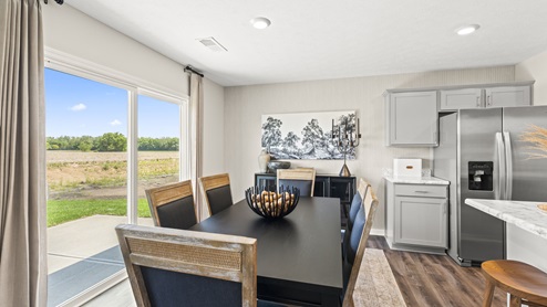 Dining area with direct access to backyard through glass sliding doors.