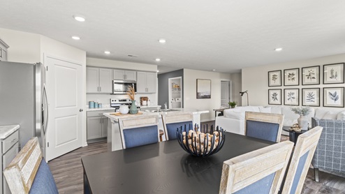 Dining area with open view of kitchen and living room.