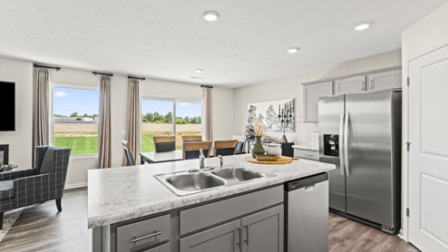 Kitchen with open view of backyard.