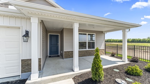 Large covered front porch with partial brick siding.