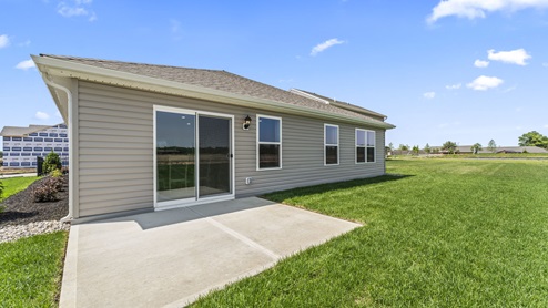 Rear exterior of home with concrete back patio.