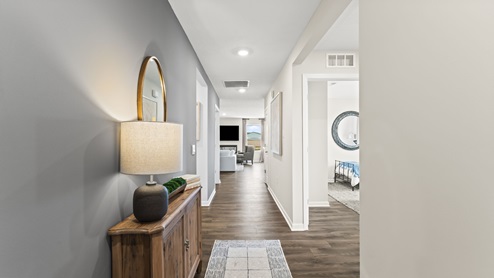 Front entryway of home with brown flooring and a blue accent wall.