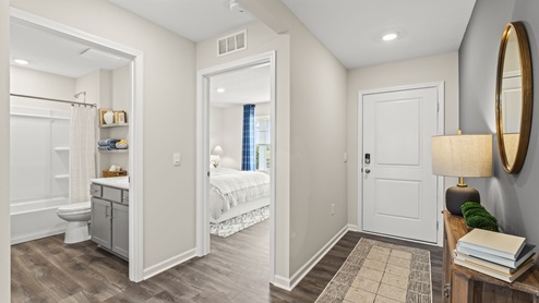 Hallway in between bedrooms and a bathroom.