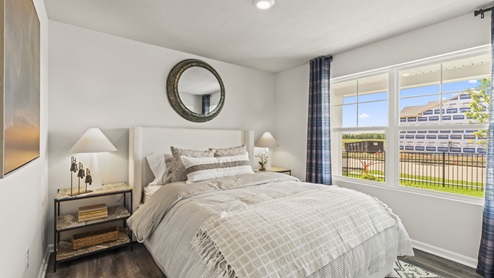 Bedroom with a large window for natural lighting.