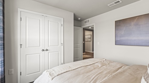 Bedroom with a double door closet.