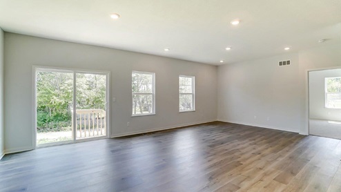great room with rear sliding door and single windows