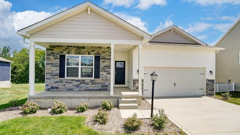 single story home with white siding, partial stone front, covered front porch, 2 car garage