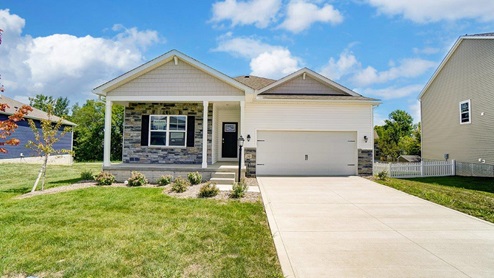 single story home with white siding, partial stone front, covered front porch, 2 car garage