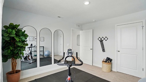 home gym with a large window, and exercise equipment