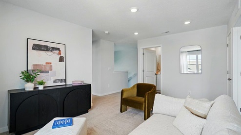 flex room featuring a sofa and a dresser with a painting above