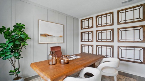 formal dining room off of the entrance of the home featuring a rectangle wood table and a large window